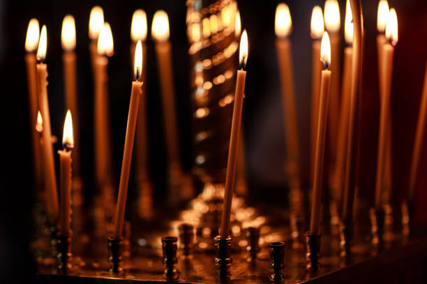 istock burning candles in church on dark background 1197118500