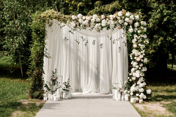 istock Wedding ceremony arch decor with white roses and green outside 1197118501