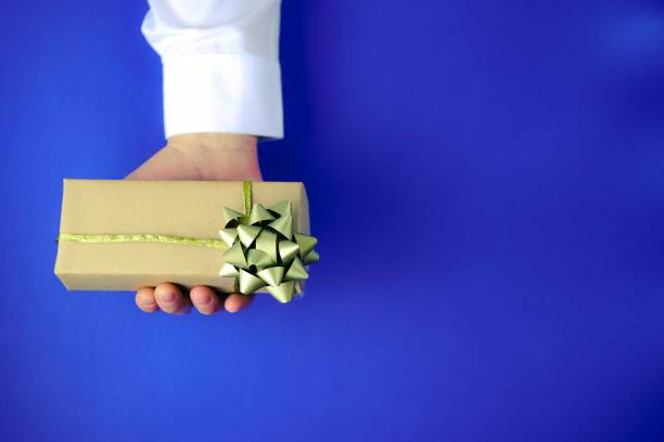 istock Male hand holding gift box. 1197120491