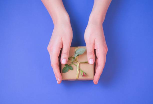 istock Female hand holding gift box. 1197120498