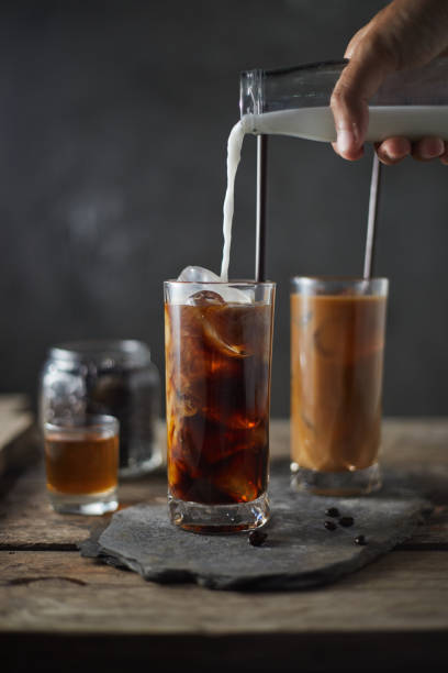 istock Ice coffee in a tall glass on wooden table. 1197123304
