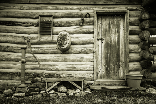 Exterior of log cabin and front door in horizontal orientation. This is a historical pioneer log cabin in a Sanilac County Park and is not a privately owned residence or property.