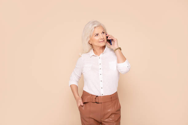 istock Smiling senior lady talking by mobile phone. 1197134288