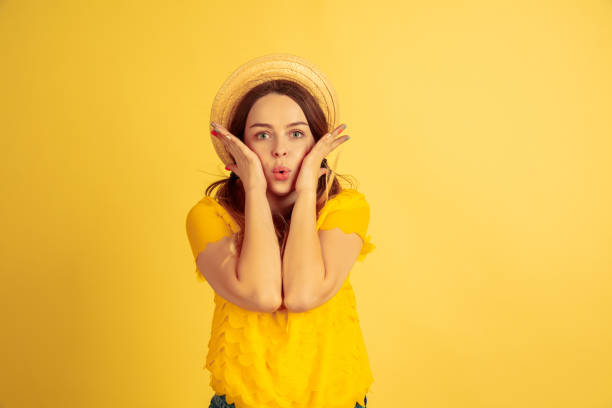 istock Caucasian woman's portrait isolated on yellow studio background 1197135092