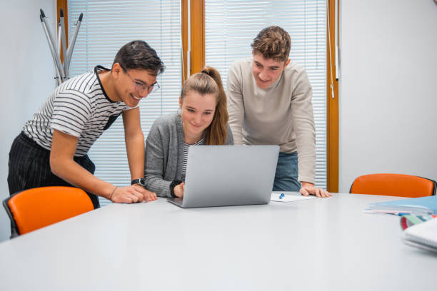 istock Small group of students using laptop in the classroom 1197135934
