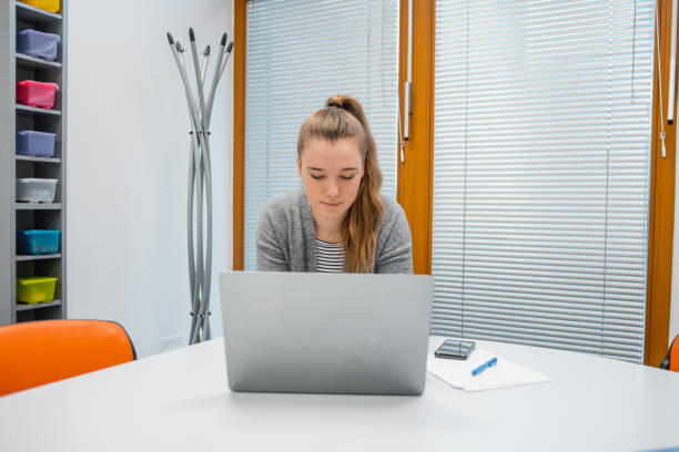 istock Caucasian female student using laptop in the classroom 1197135950
