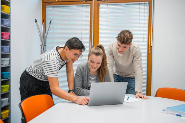 istock Small group of students using laptop in the classroom 1197135997