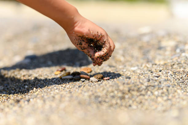 istock children's hands playing with sea sand 1197136150