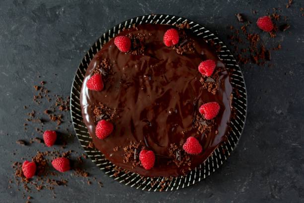 istock Chocolate cake with fruits on stone background. 1197136241