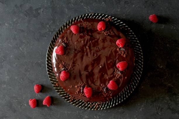 istock Chocolate cake with fruits on stone background. 1197136248