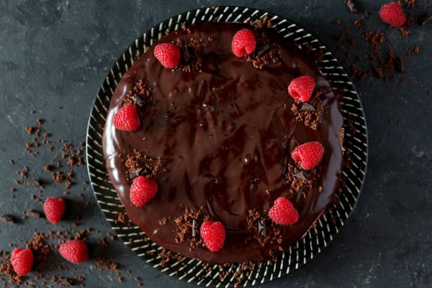 istock Chocolate cake with fruits on stone background. 1197136250