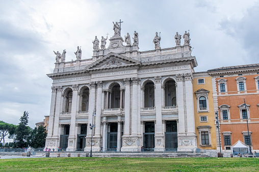 People walking next to the Archbasilica of Saint John Lateran at Rome city, Italy. Completed in 1735 it is one of the four Papal Major Basilicas.