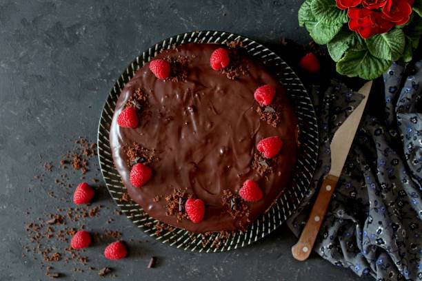 istock Chocolate cake with fruits on stone background. 1197136299