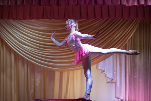 istock Beautiful girl acrobat gymnast performs on stage. 1197136888