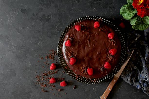 istock Chocolate cake with fruits on stone background. 1197137094