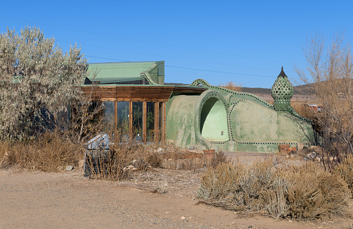 Earthship Biotecture conservation home and visitor center on Earthship Way in the desert at Tres Piedras, New Mexico
