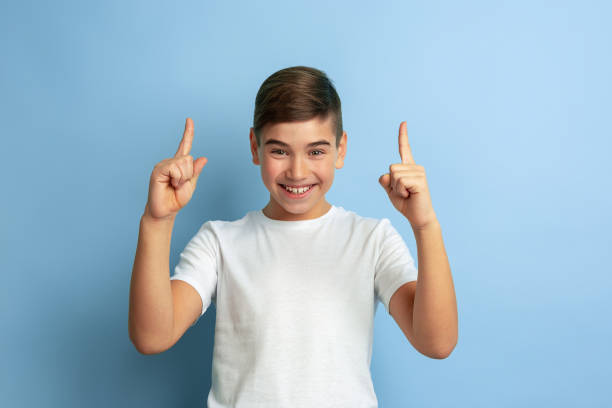 istock Caucasian teen's portrait isolated on blue studio background 1197139469