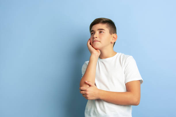 istock Caucasian teen's portrait isolated on blue studio background 1197139479