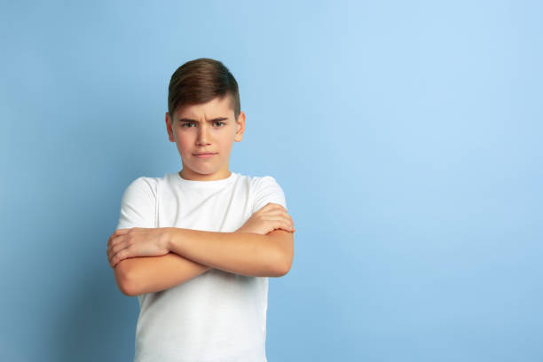 istock Caucasian teen's portrait isolated on blue studio background 1197139515
