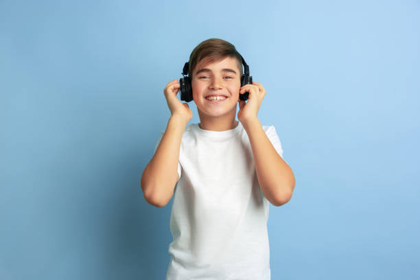 istock Caucasian teen's portrait isolated on blue studio background 1197139550