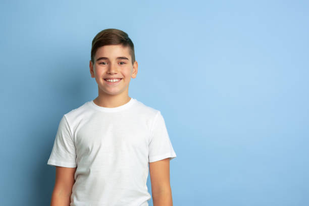 istock Caucasian teen's portrait isolated on blue studio background 1197139566