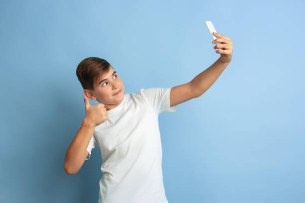 istock Caucasian teen's portrait isolated on blue studio background 1197139573