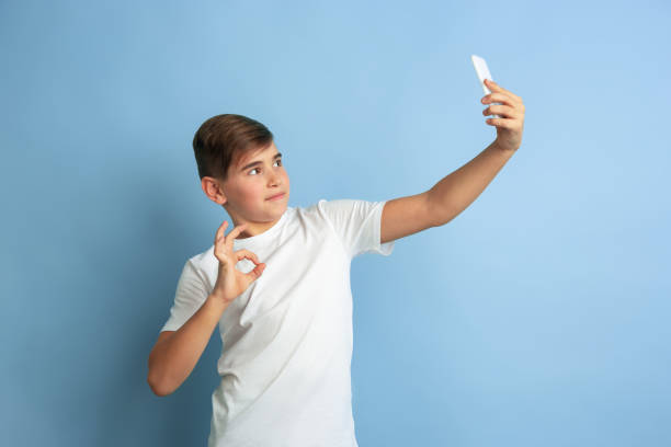istock Caucasian teen's portrait isolated on blue studio background 1197139574