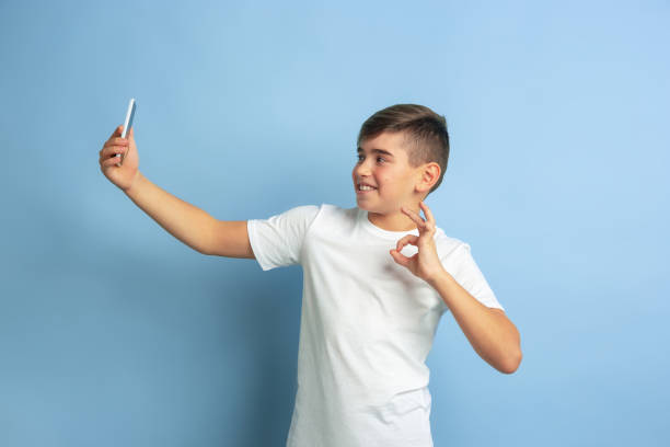 istock Caucasian teen's portrait isolated on blue studio background 1197139587