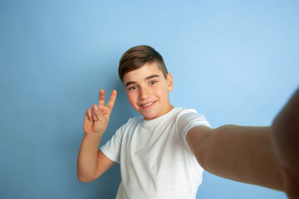 istock Caucasian teen's portrait isolated on blue studio background 1197139610