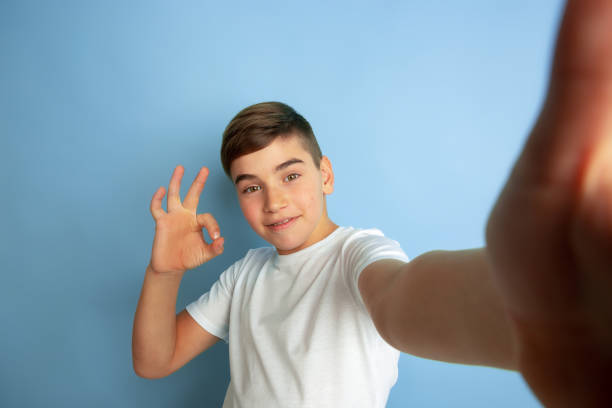 istock Caucasian teen's portrait isolated on blue studio background 1197139621