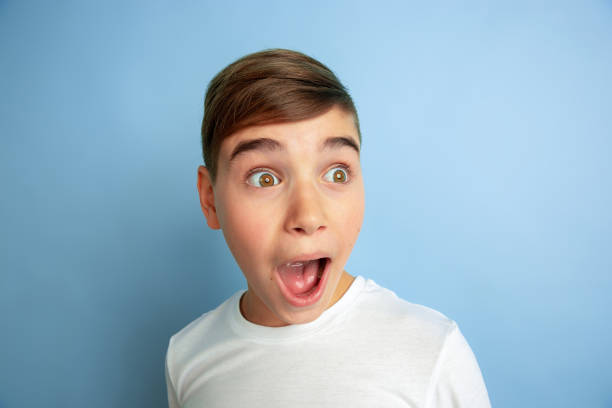 istock Caucasian teen's portrait isolated on blue studio background 1197139631
