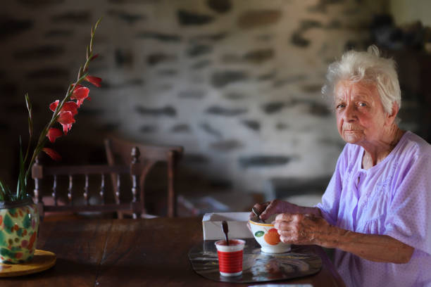 istock An old woman with Alzheimer's disease eats breakfast 1197140274