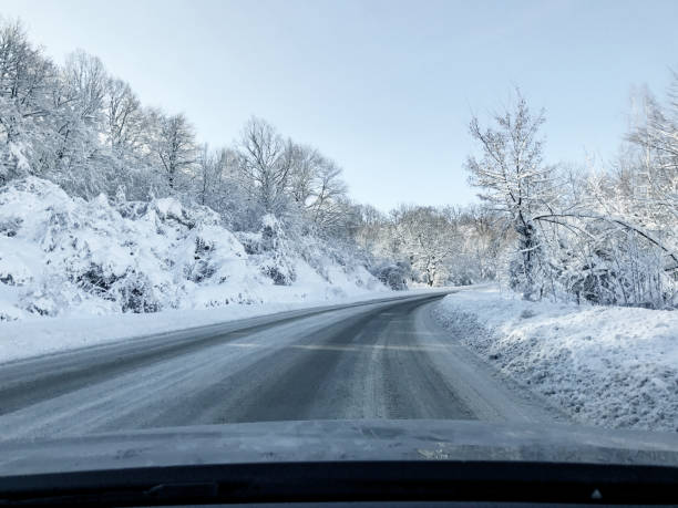 istock Beautiful winter road view between snow covered trees 1197141005