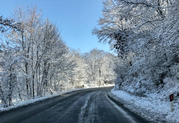 istock Beautiful winter road view between snow covered trees 1197141320