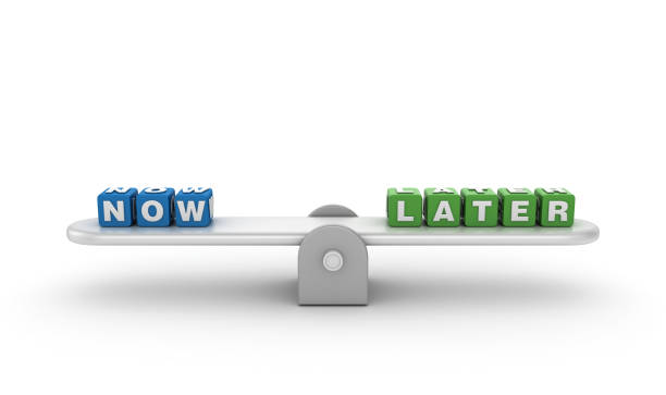 istock Seesaw with NOW LATER Buzzword Cubes - 3D Rendering 1197141362