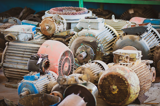 Old electric motors from industrial machines.Many disassembled retro engines