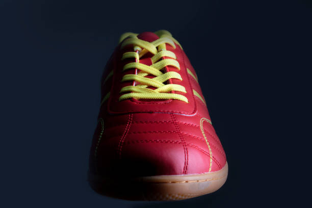 Red sneaker on a black background. Sport shoes