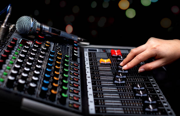 woman hands mixing audio by sound mixer analog in the recording studio - recording studio sound recording equipment record interconnect imagens e fotografias de stock