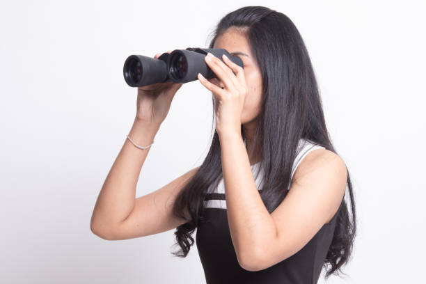istock Young Asian woman with binoculars. 1197145309