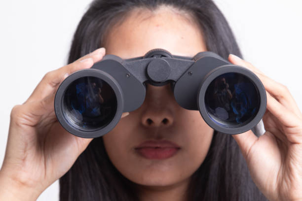 istock Young Asian woman with binoculars. 1197146483