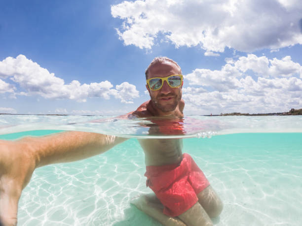 istock Underwater shot of man taking selfie on idyllic beach 1197147360