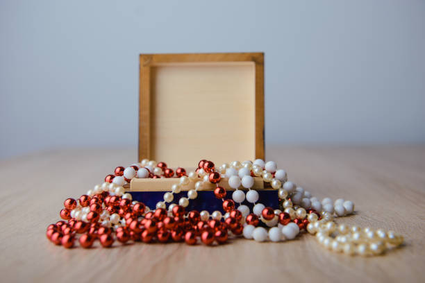 istock Gift box and red beads necklace on wooden background 1197149564