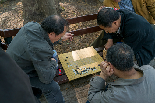 Shanghai, China - April 15th, 2018 : people playing Go in Fuxing park.