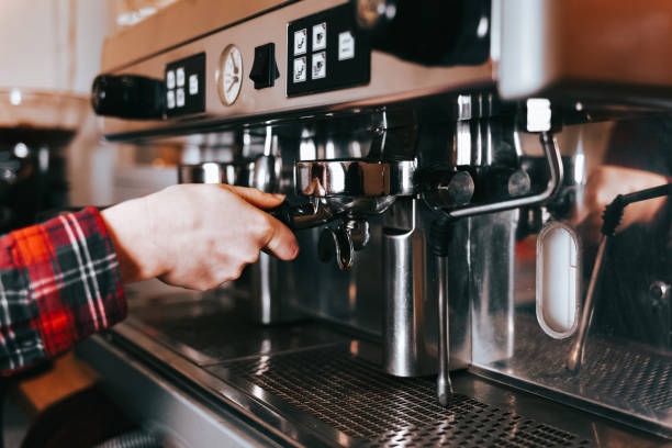 istock Barista makes aromatic coffee. Process of making latte coffee on a coffee machine in a cafe 1197154639