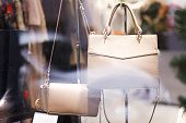 Showcase with women's handbags. Women's clothing store. Shopping