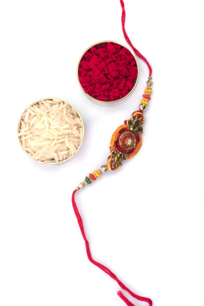 Indian festival: Raksha Bandhan background with an elegant Rakhi on a white background. A traditional Indian wrist band which is a symbol of love between Brothers and Sisters stock photo