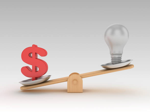 istock Seesaw Scale with Light Bulb and Dollar Sign - 3D Rendering 1197162628