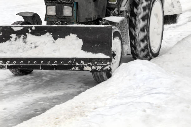 istock Tractor removes snow from snowy road 1197163932