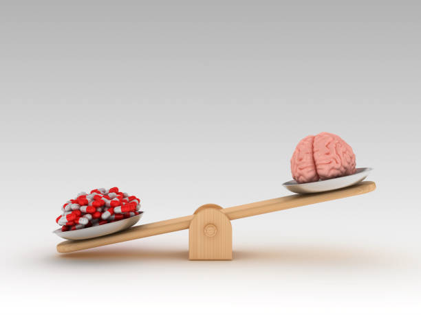 istock Seesaw Scale with Human Brains and Pills - 3D Rendering 1197164009