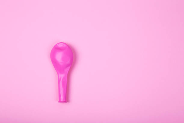 Pink rubber unblown balloons stock photo